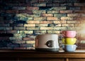 Colorful tiffin carrier and toaster on wooden cupboard Royalty Free Stock Photo