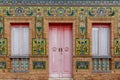 Colorful tile and red brick house front in detail