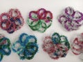 Colorful tinsel flower shapes on a white background Royalty Free Stock Photo