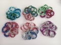 Colorful tinsel flower shapes on a white background Royalty Free Stock Photo