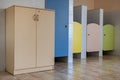 Colorful toilet doors in elementary school bathroom interior