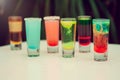Colorful toned alcoholic shots in white background. Several alcohol shots on sunny bar
