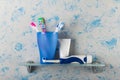 Toothbrush in glass, and electric brush, on small shelf Royalty Free Stock Photo