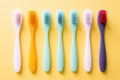 colorful toothbrushes against a yellow background