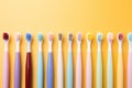 colorful toothbrushes against a yellow background