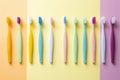 colorful toothbrushes against a yellow background
