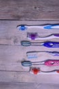 Colorful toothbrushes on a wooden background. Royalty Free Stock Photo