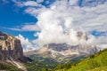 Colorful top view to Sassolungo mountain in the clouds on a Sunny summer day from Passo Sella di val Gardena Dolomites