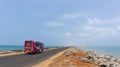 Colorful tourist bus on the road of Dhanushkodi between the sea, Rameswaram, Tamilnadu,