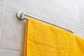 a colorful towel hang on the shelf hanger in bathroom s