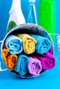 Colorful towels, bucket and cleaning products on a blue background. Detergent for different surfaces in kitchen, bathroom and Royalty Free Stock Photo