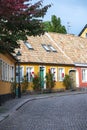 Colorful town houses along a cobblestoned street in the historic medieval old town of Lund Sweden