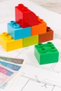 Colorful toy blocks, polish banknote and construction drawings of house. Buying or renting home concept Royalty Free Stock Photo