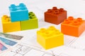 Colorful toy blocks, polish banknote and construction drawings of house. Buying or renting home concept Royalty Free Stock Photo