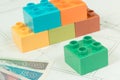 Colorful toy blocks, polish currency money and construction housing plan. Building, buying or renting home concept Royalty Free Stock Photo