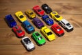 Colorful toy cars side view on a wooden floor background. Toys for children Royalty Free Stock Photo