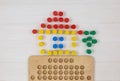 Colorful toy house with wooden blocks for children on white table. Games for kindergarten, preschool or daycare. Education, Royalty Free Stock Photo