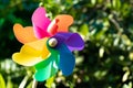 Color toy plastic turbine windmill on green background