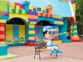 Colorful toy town building with coloful blocks and a boy cartoon