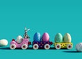 Colorful toy train with bunny and Easter eggs on turquoise blue background Royalty Free Stock Photo