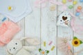 Colorful toys and Baby Clothing frame on white wooden background. Plush toy hare mockup with copy space for your text Royalty Free Stock Photo