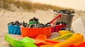 colorful toys on the beach for children to dig. Sand is used to build castles and shapes Royalty Free Stock Photo