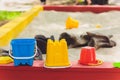 colorful toys plastic sand molds rakes and spoons on a children& x27;s sandbox. Royalty Free Stock Photo