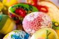 Colorful traditional Easter eggs with floral ornaments, origami decorations and crewel wool, close-up view