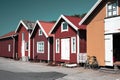 Colorful traditional fisherman huts, boathouses in row small harbor. Storage for fishing or rented as Holiday cottage