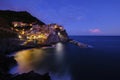 Colorful traditional houses on the rock over Mediterranean sea on dramatic sunset, Manarola, Cinque Terre, Italy Royalty Free Stock Photo