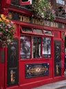 Colorful Irish Pub exterior in Temple Bar Dublin with flowers outside.