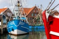 Colorful traditional old german fishing cutter boats moored Neuharlingersiel harbor Wadden sea East Frisia Northern Royalty Free Stock Photo