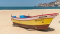 Colorful traditional old wooden fishing boat on the beach of fishing village of Nazare Royalty Free Stock Photo