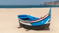 Colorful traditional old wooden fishing boat on the beach of fishing village of Nazare Royalty Free Stock Photo