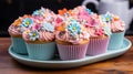 Colorful tray of cupcakes decorated with edible flowers for celebration and festive occasions Royalty Free Stock Photo