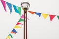 Colorful triangular cloth flags hanging on ropes tied to a lamppost, decoration for festival, carnival, holiday Royalty Free Stock Photo