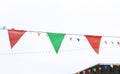 Colorful triangular Flags Hanging in the white sky outdoor Royalty Free Stock Photo