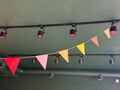 Colorful triangular pennant flags hanging in cafe interior. Celebration, joy, and cheerful design in festive public space. Royalty Free Stock Photo