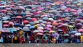 Colorful tribal local crowd with umbrellas in the rain