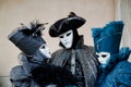 Colorful trio carnival black-blue mask and costume at the traditional festival in Venice, Italy