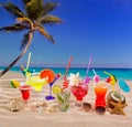 Colorful tropical cocktails at beach on white sand Royalty Free Stock Photo