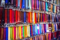 Colorful trouser leather belts hang in a row for sale on market in Florence, Firenze, Tuscany, Italy