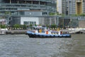 Colorful tugboat in front of luxury shopping-mall Royalty Free Stock Photo