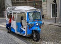 Colorful tuktuk on a typical cobbled street in the old town city center waiting for tourists in Porto, Portugal