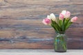 Colorful tulips flowers on wooden table. Top view with copy space. Toned picture by instagram filter Royalty Free Stock Photo