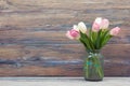 Colorful tulips flowers on wooden table. Top view with copy space. Toned picture by instagram filter Royalty Free Stock Photo