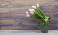 Colorful tulips flowers on wooden table. Top view with copy space. Toned picture by instagram filter Royalty Free Stock Photo