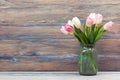 Colorful tulips flowers on wooden table. Top view with copy space. Toned picture by instagram filter Royalty Free Stock Photo