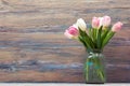 Colorful tulips flowers on wooden table. Top view with copy space. Toned picture by instagram filter Royalty Free Stock Photo