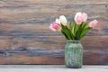 Colorful tulips flowers on wooden table. Top view with copy space. Toned picture by instagram filter Royalty Free Stock Photo